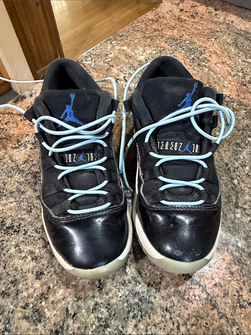 Jordan 1Y Black and Light Blue Retro Low-Top Sneakers